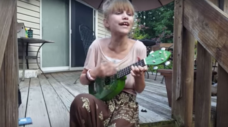 grace singing backyard with ukulele