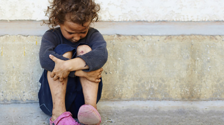Poor Child Crying Holding Knees On Ground