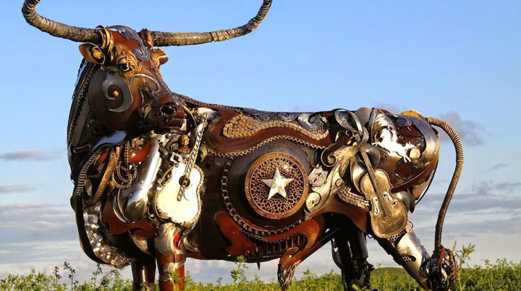 cow sculpture made from old farm tools inspired by Texas