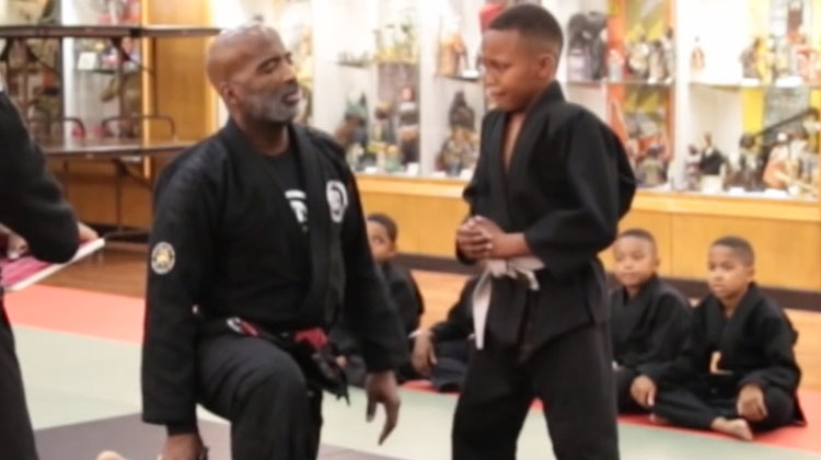 boy crying during karate test with teacher