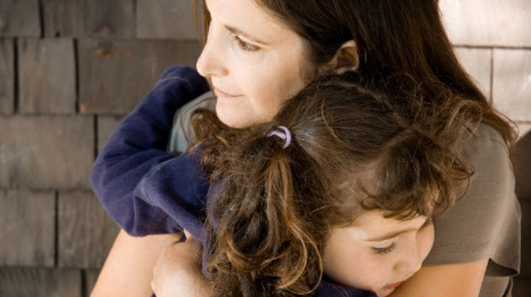 mom holding daughter