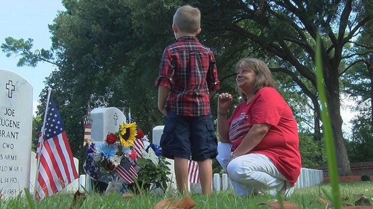 mom and little boy at grave
