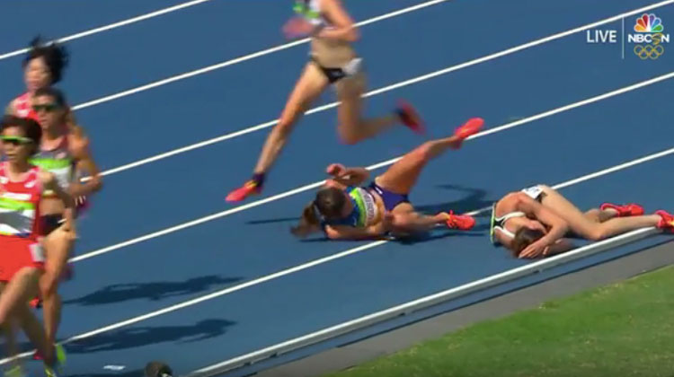 runners fall on ground during race