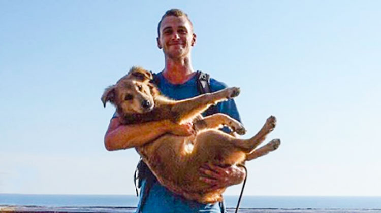 man holding brown dog