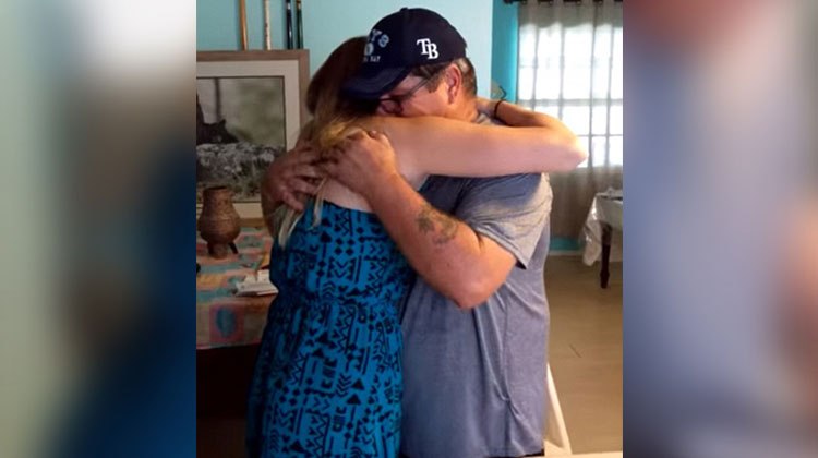 girl hugs crying stepdad