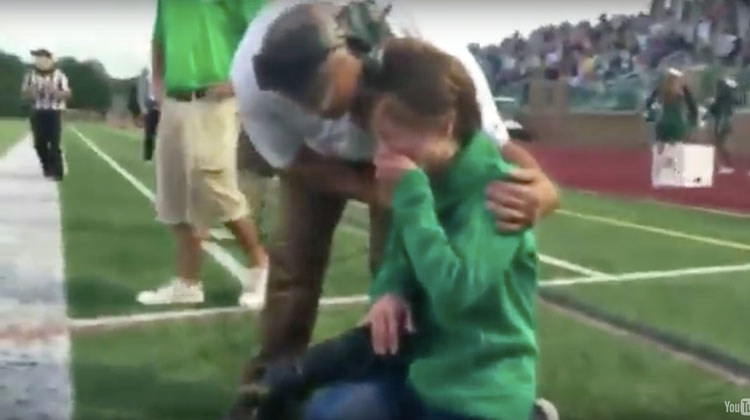 mom collapses in tears held by coach