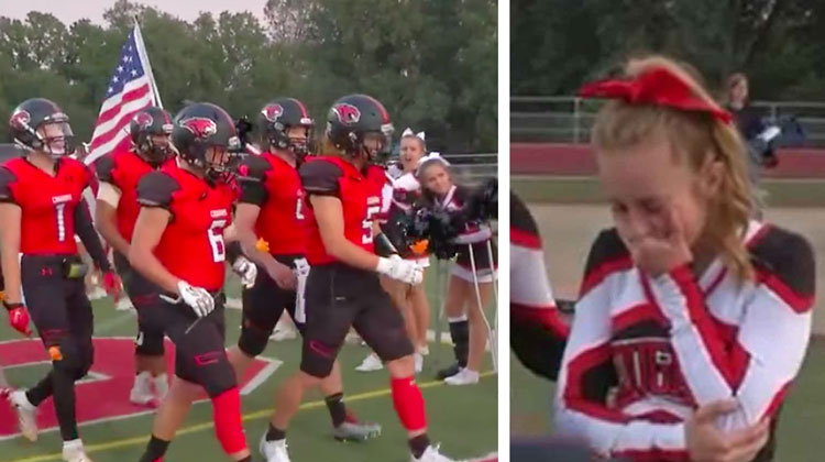 football players in red in line, cheerleader speechless with hand over mouth