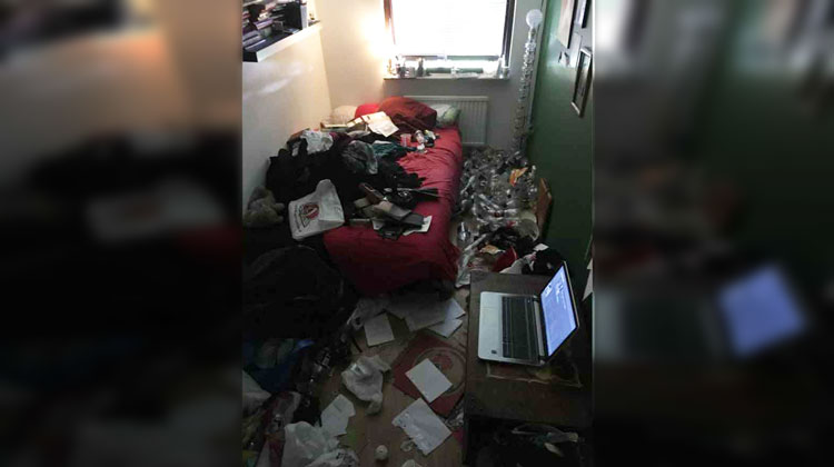 extremely messy room with piles of clothes and water bottles