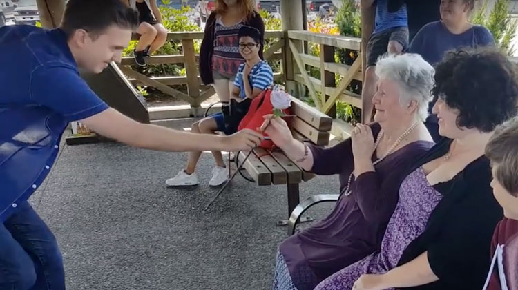 boy hands grandma white rose