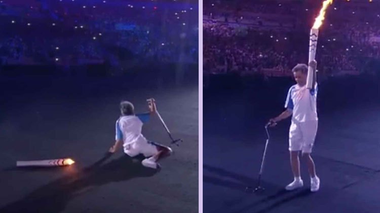 torchbearer falls on ground, then stands and continues