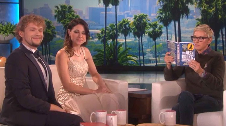 couple sits and watches ellen read book