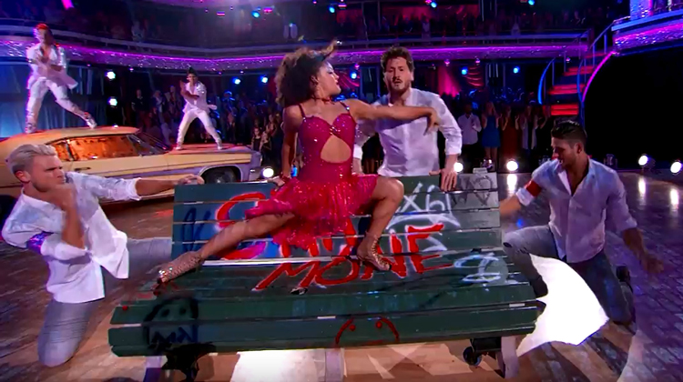 laurie in red sparkling outfit on bench