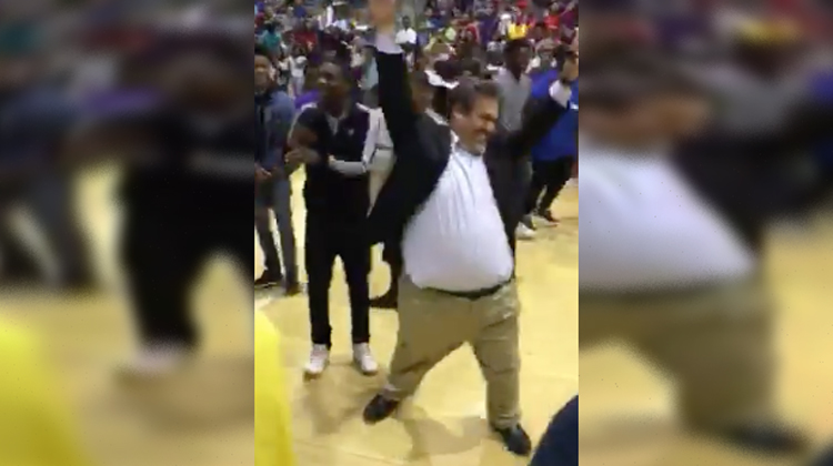 man in suit dancing at pep rally