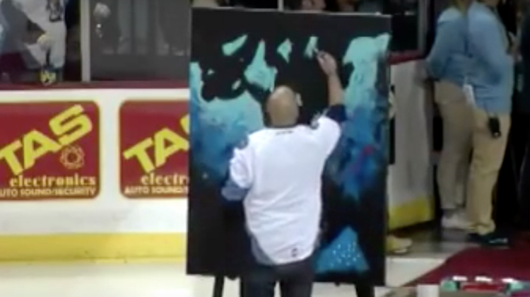 man paints on ice