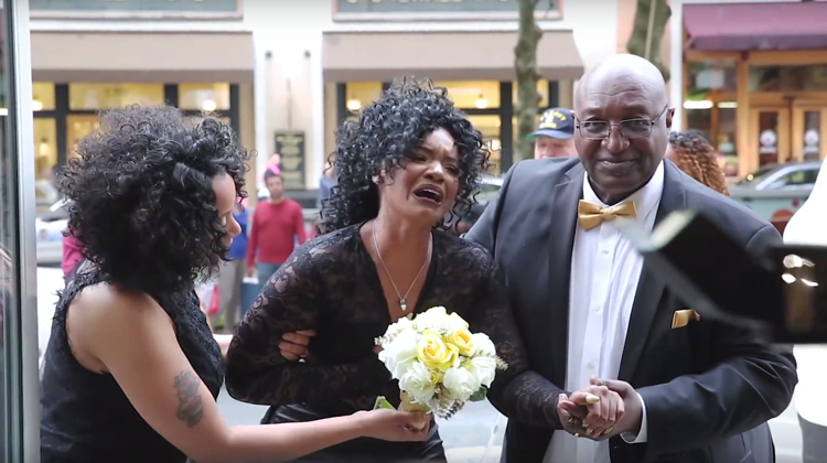 woman in tears when she sees her surprise wedding. wearing black lace dress