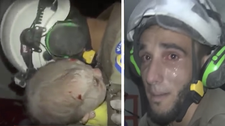 syrian rescuer holds baby in arms then cries