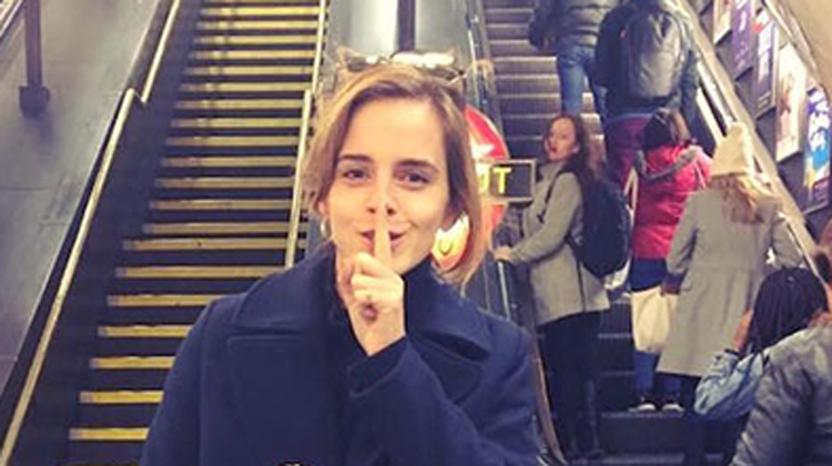 emma watson with finger over mouth in underground