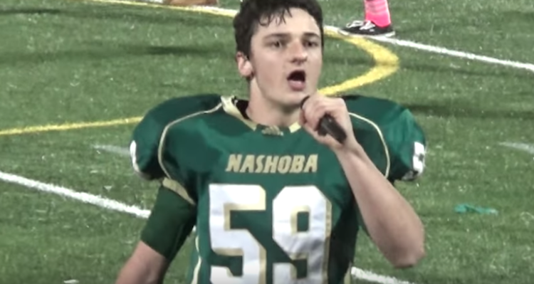 sam keith singing the national anthem at a football game.