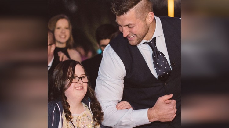 tim tebow escorting girl in white dress