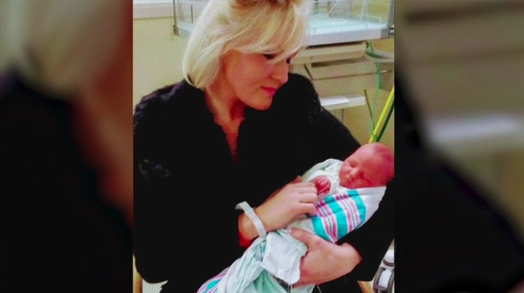 mom holding baby