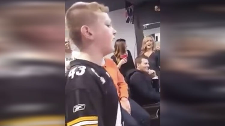 boy singing with shocked family