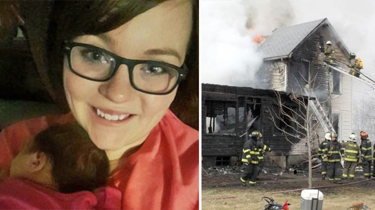 mom with newborn and smoldering house with firefighters