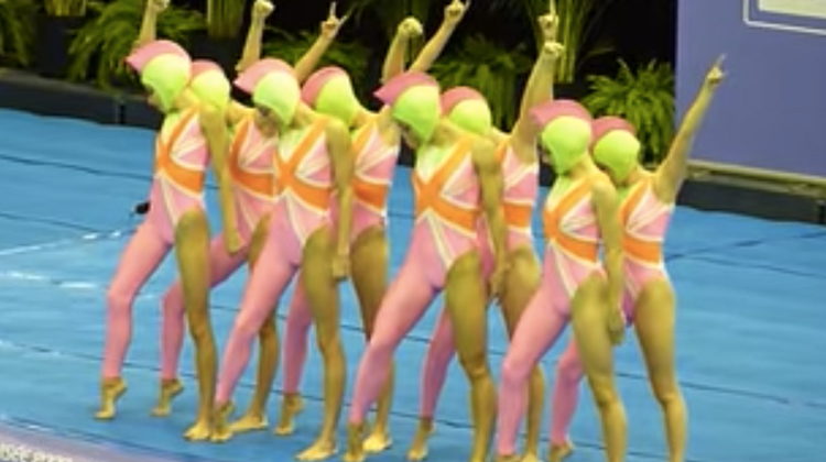 synchronized team in neon costumes