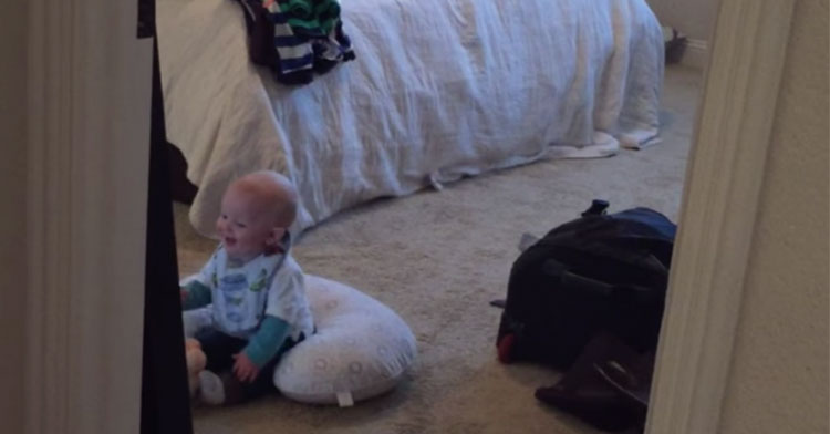 baby laughing at reflection in mirror