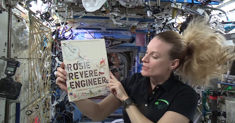astronaut reads in space