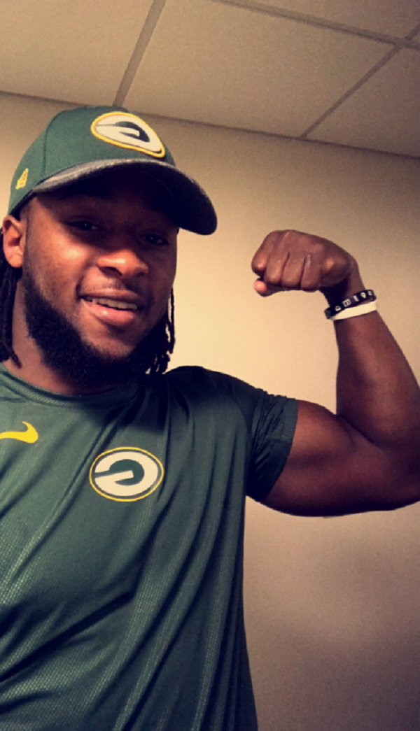 Aaron Jones Packers player pushes wheelchair