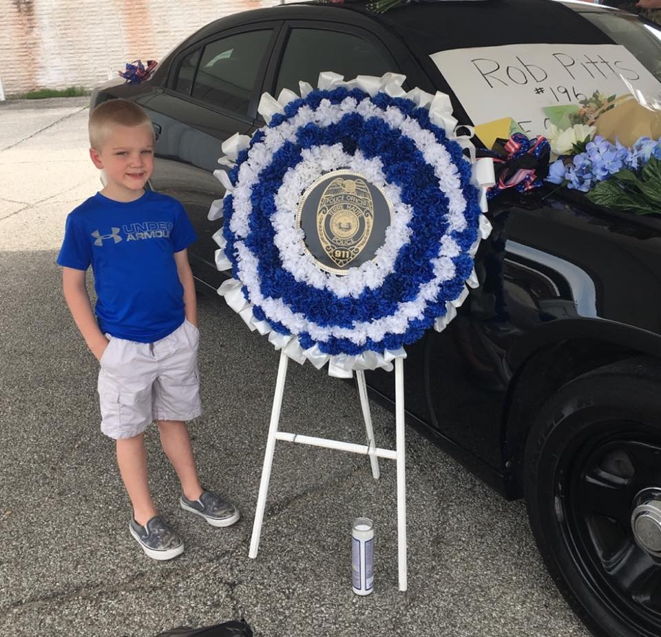 dakota-pitts-standing-next-to-wreath