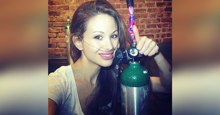 girl posing with oxygen tank
