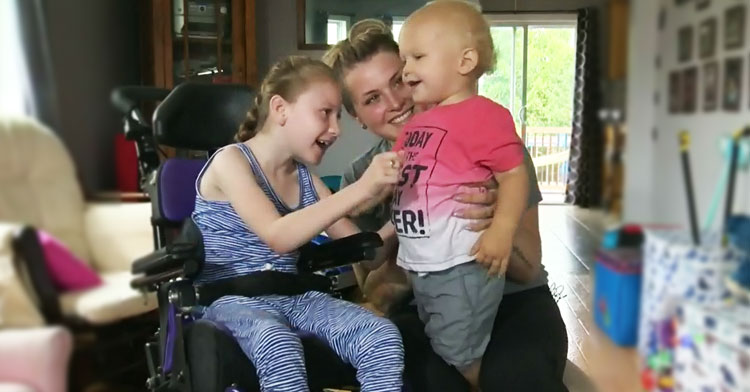 girl with cerebral palsy and baby brother