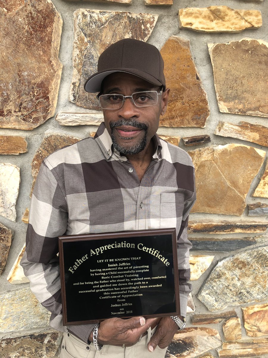 isaiah holds up certificate