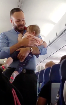 flight attendant comforts baby