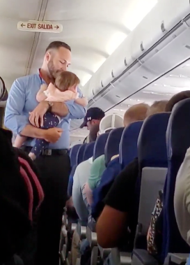 flight attendant comforts baby