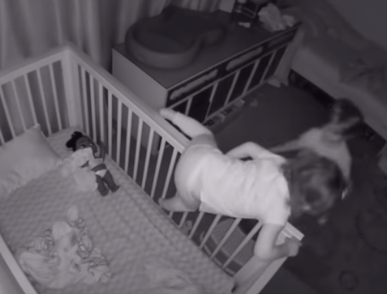 brother helps sister out of crib