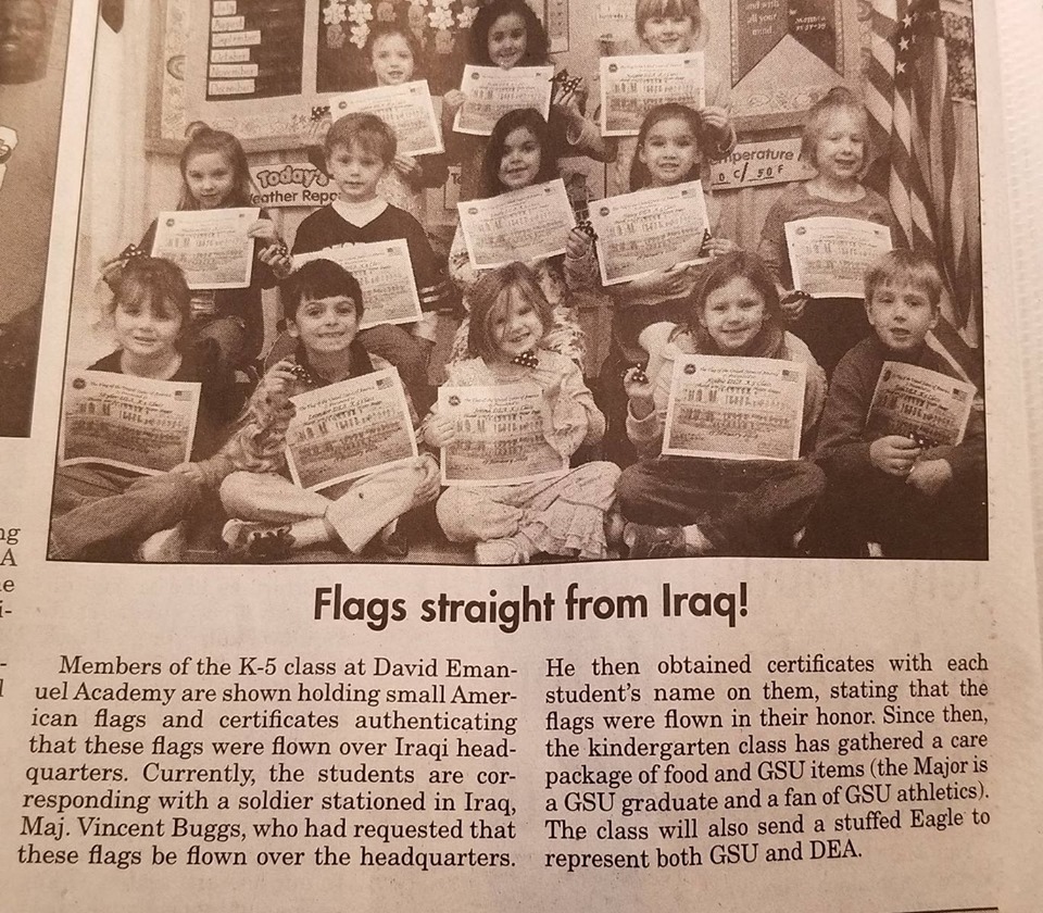 students hold up flags in newspaper