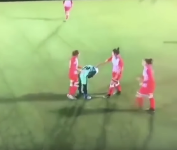 soccer players help opponent