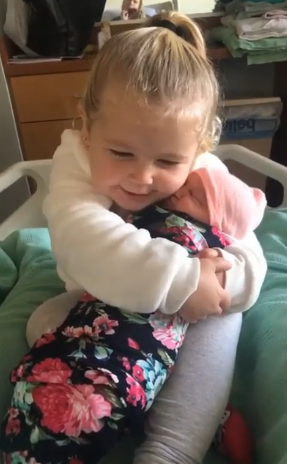 molly hugs baby sister