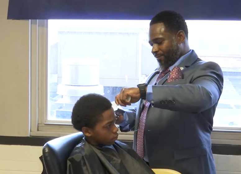 principal newton cuts hair