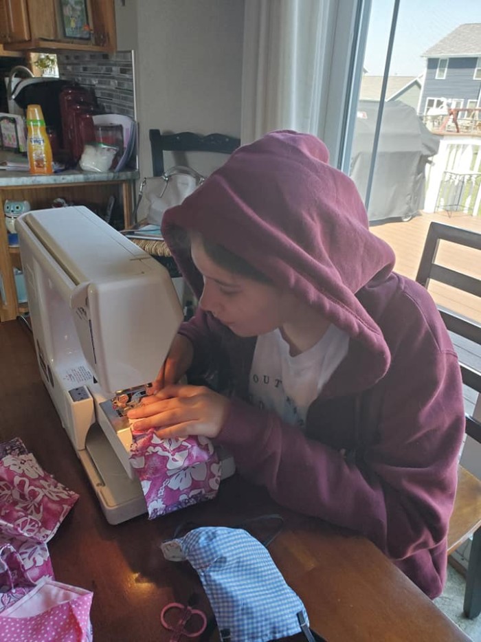 woman at sewing machine, sewing mask