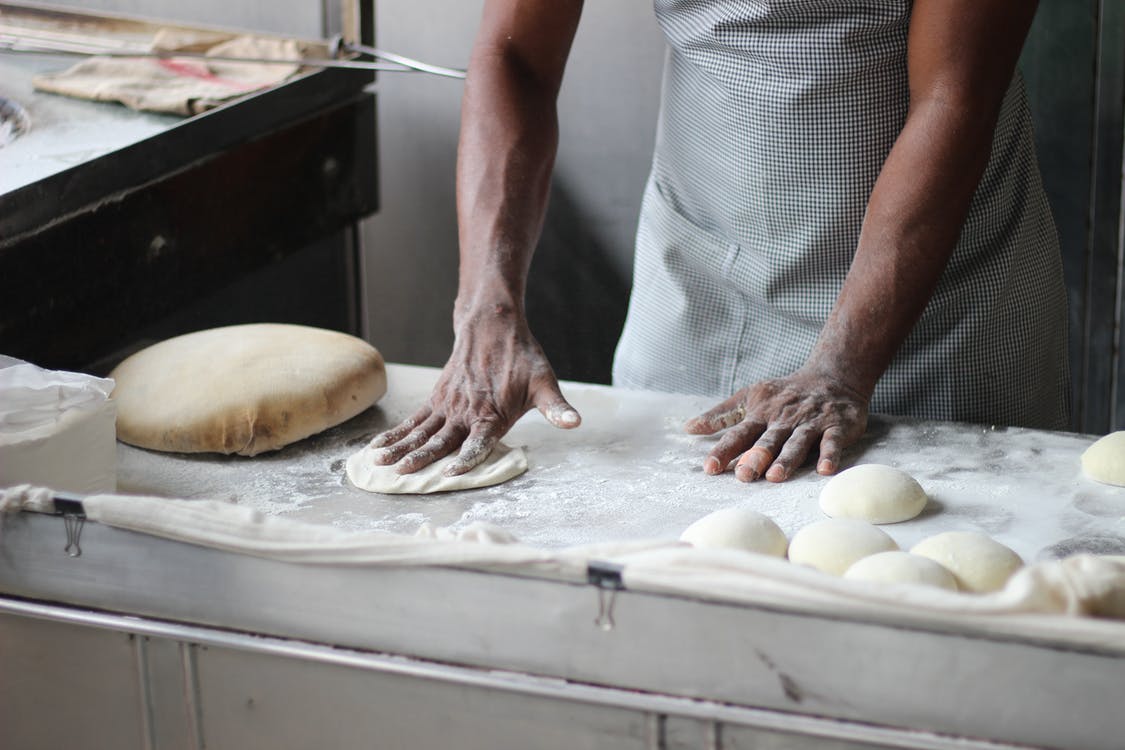 man rolling dough