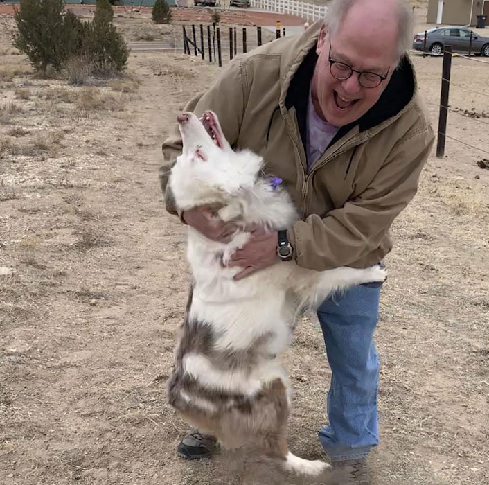 man hugging a dog