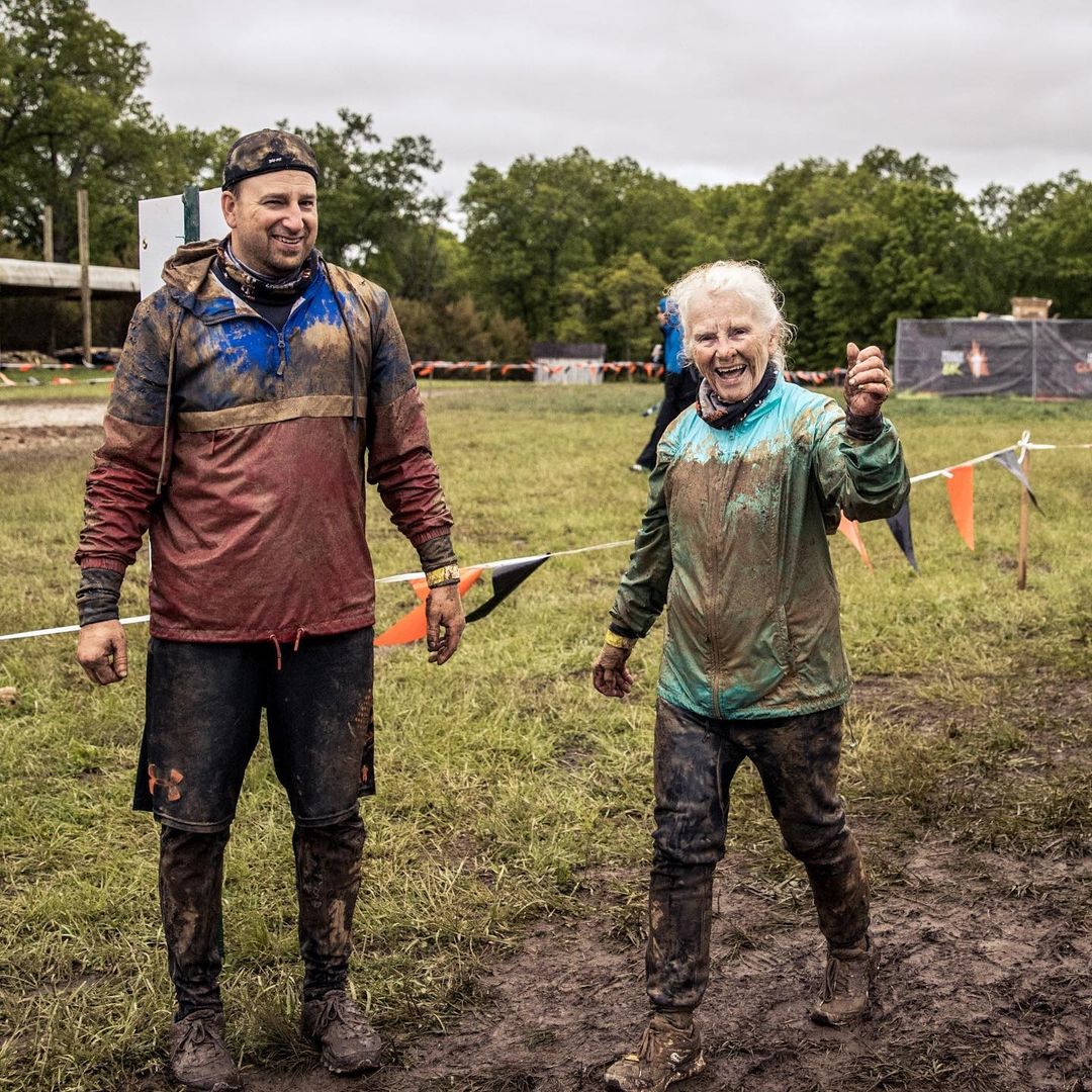 muddy man standing next to his muddy mom
