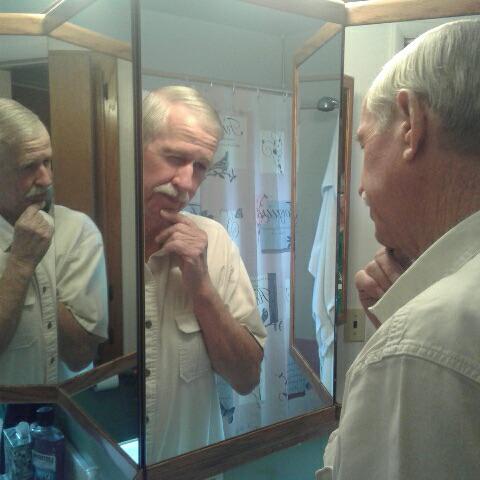 grandpa with two reflections of himself in mirror