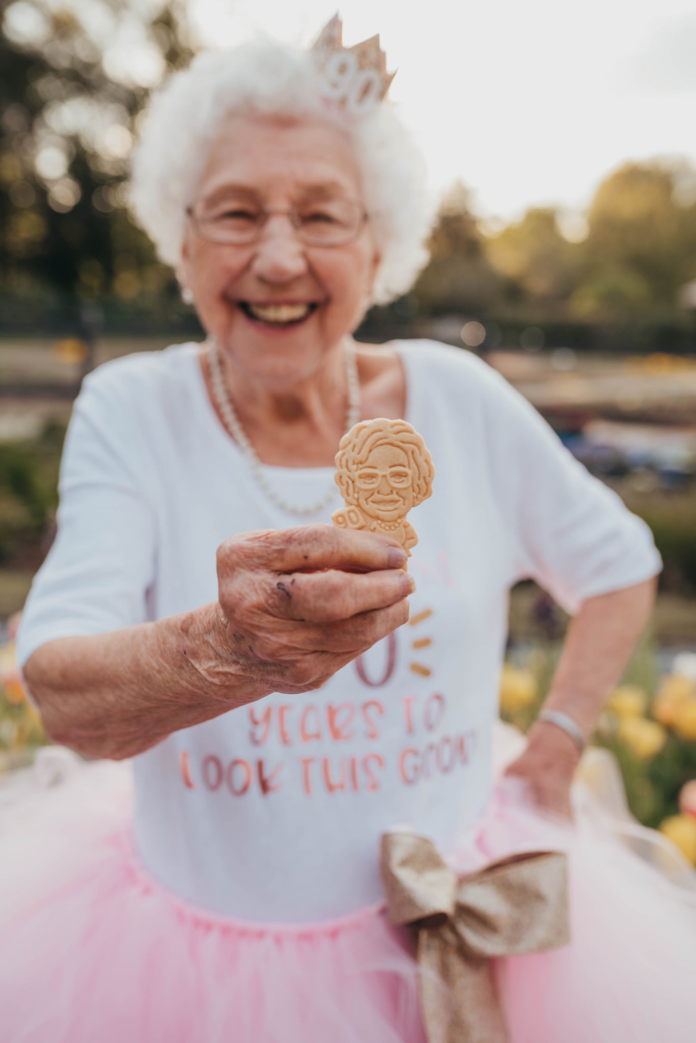 grandma holding a cookie and smiling