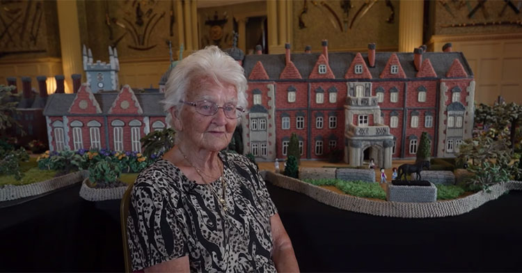 Margaret sitting in front of the completed replica