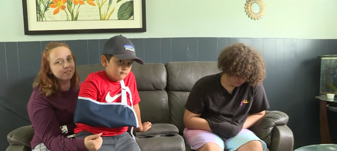 mom sitting on couch with two sons