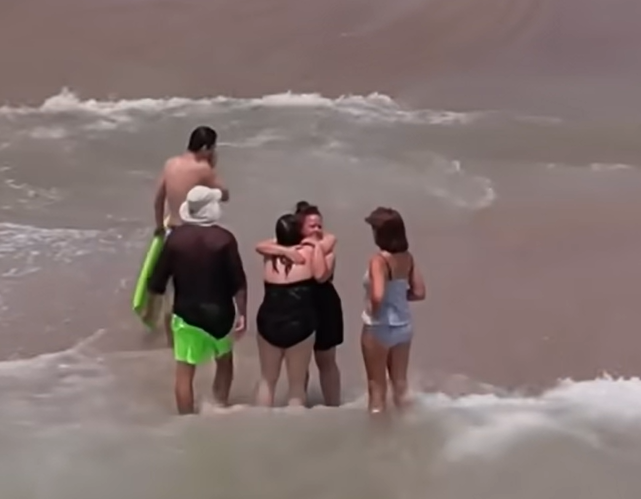 moms hug after ocean rescue